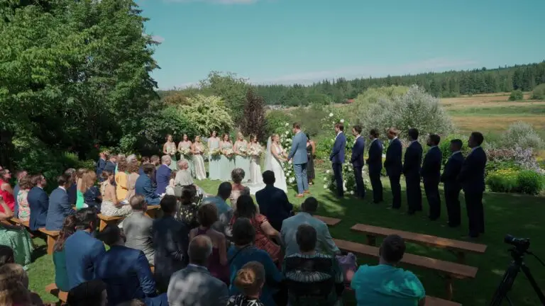 An outdoor wedding ceremony overlooking a wooded valley