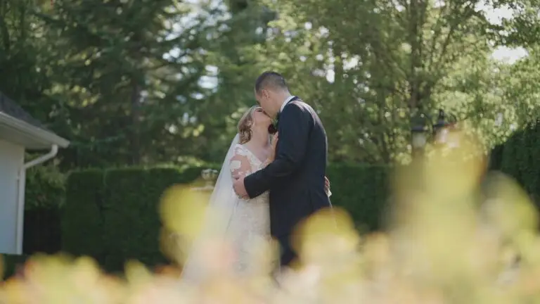 Newlyweds kissing in a garden